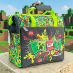 Lonchera Magia Nostálgica de Minecraft en verde y negro con diseño de dinamita y texto Boom y dos asas de transporte